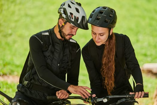 A blissful couple, adorned in professional cycling gear, enjoys a romantic bicycle ride through a park, surrounded by modern natural attractions, radiating love and happiness.