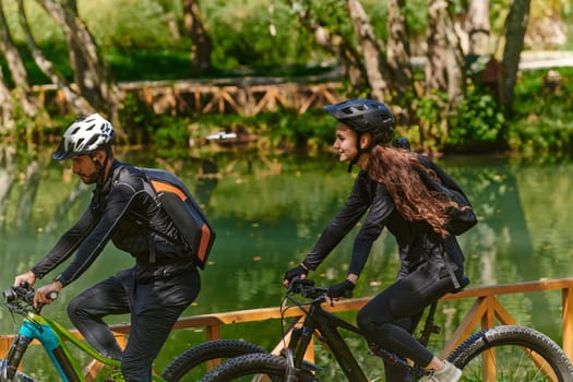 A blissful couple, adorned in professional cycling gear, enjoys a romantic bicycle ride through a park, surrounded by modern natural attractions, radiating love and happiness.