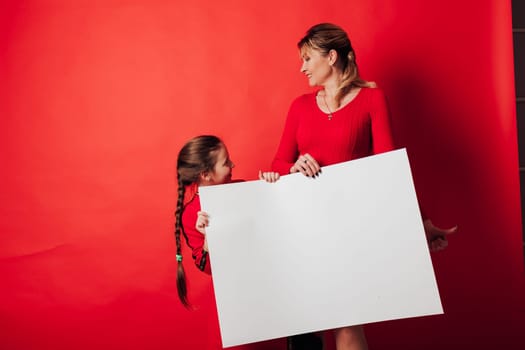 girl and woman holds a sign for background inscriptions