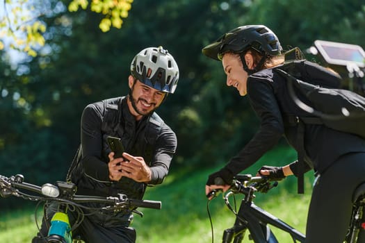 A sweet couple, equipped with bicycles and engrossed in coordinating their journey, checks their GPS mobile and watches while planning scenic routes in the park, seamlessly blending technology and outdoor adventure for a delightful cycling experience.