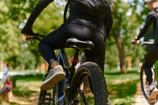 A sports bicycle races through the park, its components in focused motion spinning wheels, agile pedals, and sleek handlebars creating a dynamic spectacle of athleticism and speed against the backdrop of lush greenery.