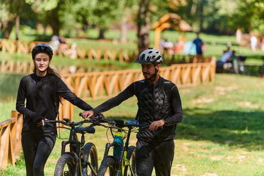 A blissful couple, adorned in professional cycling gear, enjoys a romantic bicycle ride through a park, surrounded by modern natural attractions, radiating love and happiness.