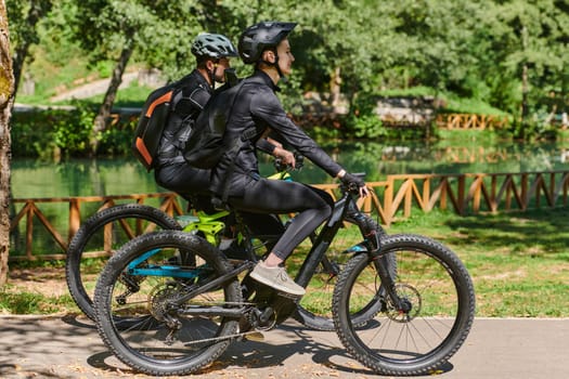 A blissful couple, adorned in professional cycling gear, enjoys a romantic bicycle ride through a park, surrounded by modern natural attractions, radiating love and happiness.