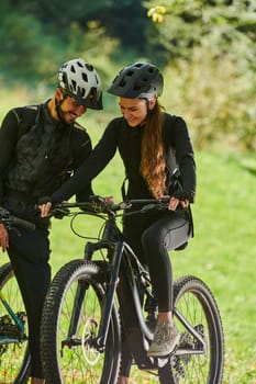 A sweet couple, equipped with bicycles and engrossed in coordinating their journey, checks their GPS mobile and watches while planning scenic routes in the park, seamlessly blending technology and outdoor adventure for a delightful cycling experience.