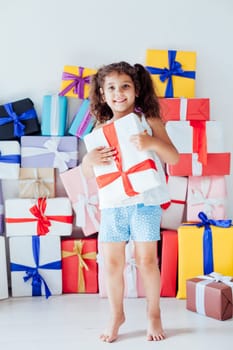 Beautiful little girl got a lot of gifts for birthday celebration
