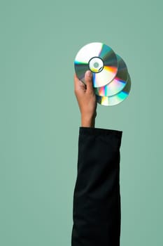 Businessman's hand holding electric CD on isolated background. Eco-business recycle waste policy in corporate responsibility. Reuse, reduce and recycle for sustainability environment. Quaint