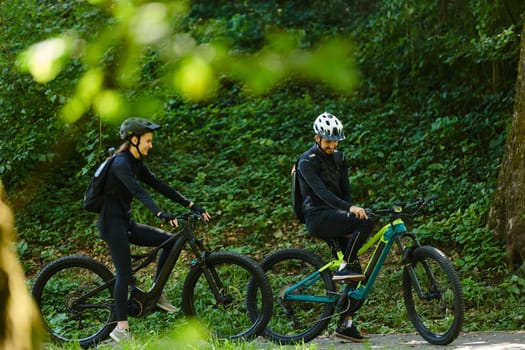 A blissful couple, adorned in professional cycling gear, enjoys a romantic bicycle ride through a park, surrounded by modern natural attractions, radiating love and happiness.