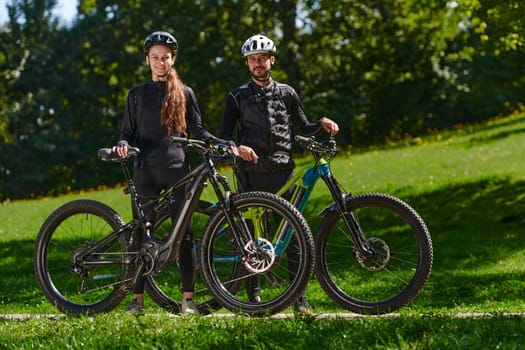 A sweet couple, equipped with bicycles and engrossed in coordinating their journey, checks their GPS mobile and watches while planning scenic routes in the park, seamlessly blending technology and outdoor adventure for a delightful cycling experience.