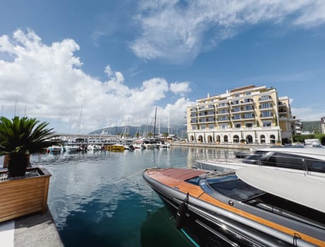 Motor yachts are moored off the coast overlooking the Regent Hotel. Porto, Montenegro. High quality photo