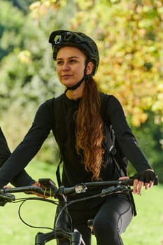 In the radiant embrace of a sunny day, a joyous girl, adorned in professional cycling gear, finds pure bliss and vitality as she cruises through the park on her bicycle, her infectious laughter echoing the carefree harmony of the moment.