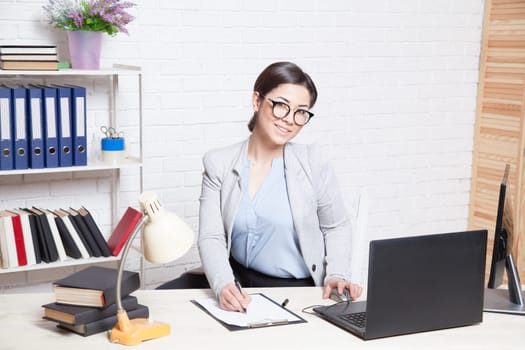 business girl works at a computer in the Office 1