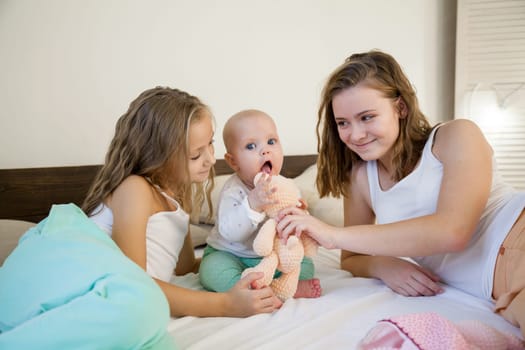 three sisters girl babe in the bedroom on the bed