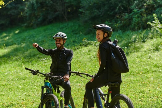 A blissful couple, adorned in professional cycling gear, enjoys a romantic bicycle ride through a park, surrounded by modern natural attractions, radiating love and happiness.