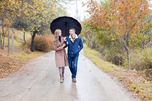 a guy with a girl go under umbrella rain good mood