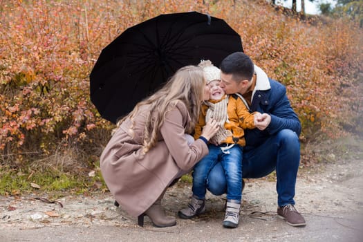 family autumn in the Park in the rain umbrella 1