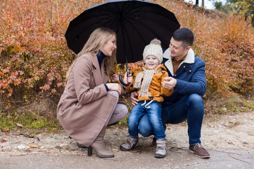 family autumn in the Park in the rain umbrella 1