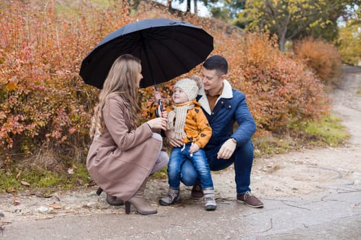 family autumn in the Park in the rain umbrella 1