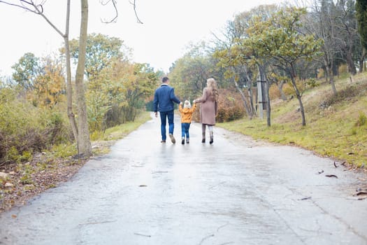 a family with a son go on doroke in the rain