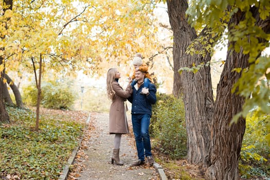 family to boys walk on autumn Woods 1