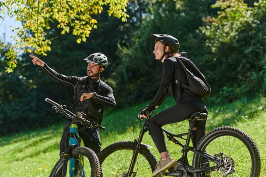 A sweet couple, equipped with bicycles and engrossed in coordinating their journey, checks their GPS mobile and watches while planning scenic routes in the park, seamlessly blending technology and outdoor adventure for a delightful cycling experience.