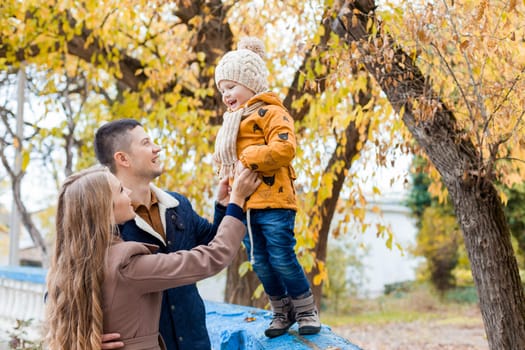 a family with a young boy in the autumn forest walk 1