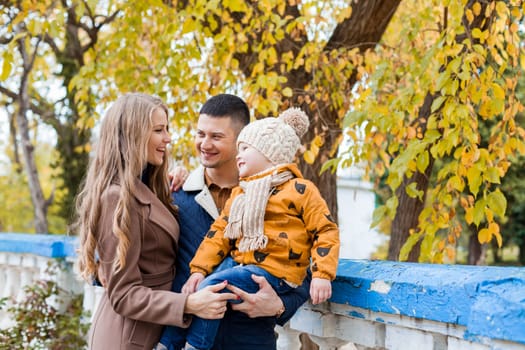 a family with a boy walking in the autumn Park happiness 1