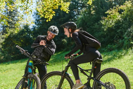 A sweet couple, equipped with bicycles and engrossed in coordinating their journey, checks their GPS mobile and watches while planning scenic routes in the park, seamlessly blending technology and outdoor adventure for a delightful cycling experience.