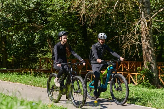 A blissful couple, adorned in professional cycling gear, enjoys a romantic bicycle ride through a park, surrounded by modern natural attractions, radiating love and happiness.