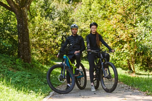 A blissful couple, adorned in professional cycling gear, enjoys a romantic bicycle ride through a park, surrounded by modern natural attractions, radiating love and happiness.