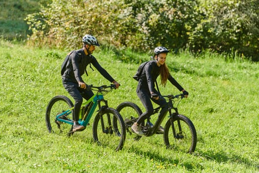 A blissful couple, adorned in professional cycling gear, enjoys a romantic bicycle ride through a park, surrounded by modern natural attractions, radiating love and happiness.