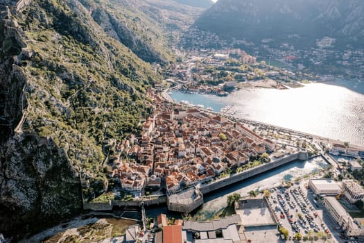 Stone fortress walls of a resort town on the banks of a canal. Kotor, Montenegro. High quality photo