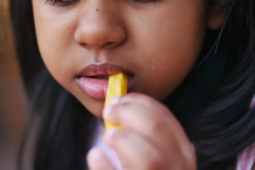 child eating french fries close up ,