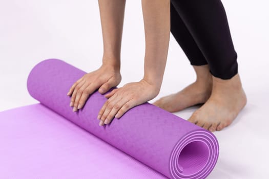 Young attractive asian woman portrait in sportswear with exercising mat. Healthy exercise and workout routine lifestyle concept. Studio shot isolated background. Vigorous