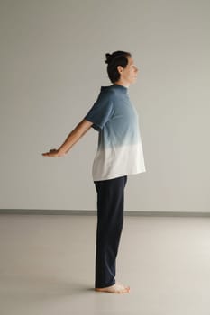 a man in a sports uniform does yoga in a fitness room. the concept of a healthy lifestyle.