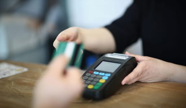 Seller offers buyer to pay for purchase credit card. Payment for goods through payment terminal concept