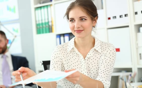 Woman marketer shows colleagues financial analytics chart. Sales growth statistics in charts concept