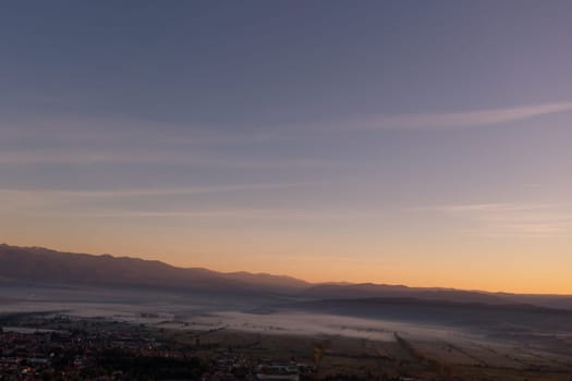 aerial view of foggy morning autumn mountains with clouds bansko bulgaria.