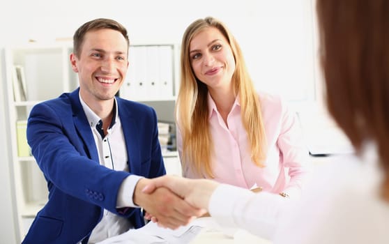 Family couple or business team shaking hands with client. Handshake of partners and conclusion of business contract