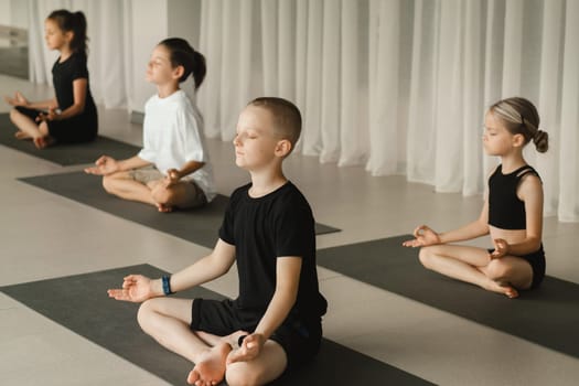 Children do Yoga in the fitness room. Children's gymnastics.