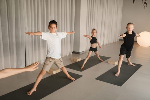 Children do Yoga in the fitness room. Children's gymnastics.