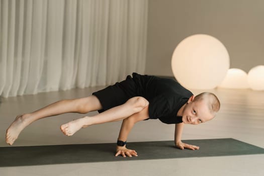 A child practices yoga poses indoors. Children's yoga.