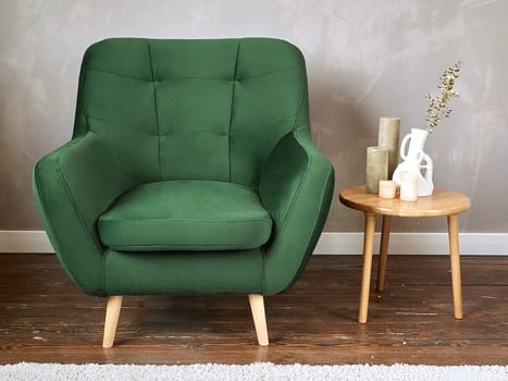 furniture, interior, home design. modern green fabric armchair with wooden legs, front view.