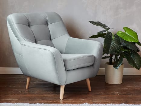 furniture, interior, home design. modern blue fabric armchair with wooden legs, side view.