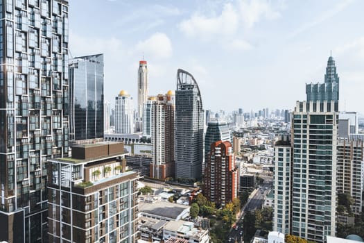 Closeup image of Bangkok cityscape. Modern cityscape surrounded with architectural building with day light and blue sky. Side view. Business background. Day light. Ornamented.