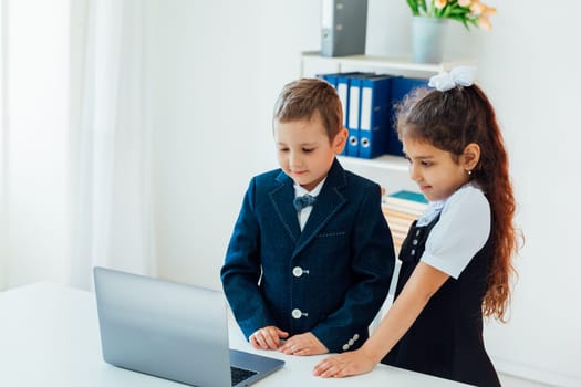 Boy and girl studying at the computer online