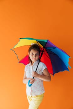 girl under colorful umbrella from the rain