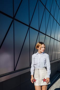 fashionable woman near glass wall showcase