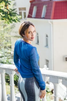 woman in blue clothes near railing walk