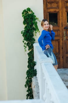 woman in blue clothes at the front door