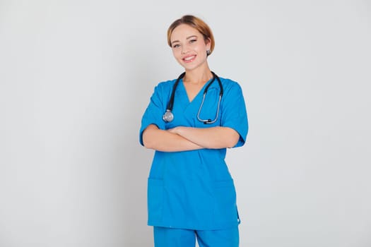 Female doctor with stethoscope on white background